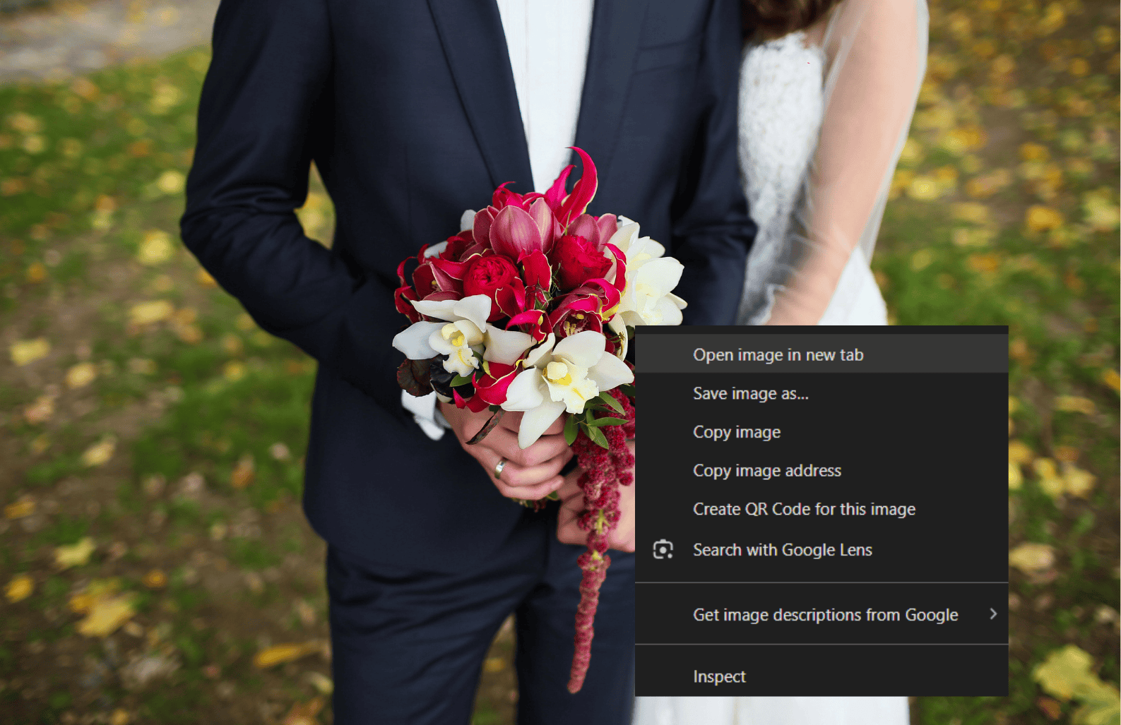 A person holding a bouquet with a browser right-click context menu displayed on the image.