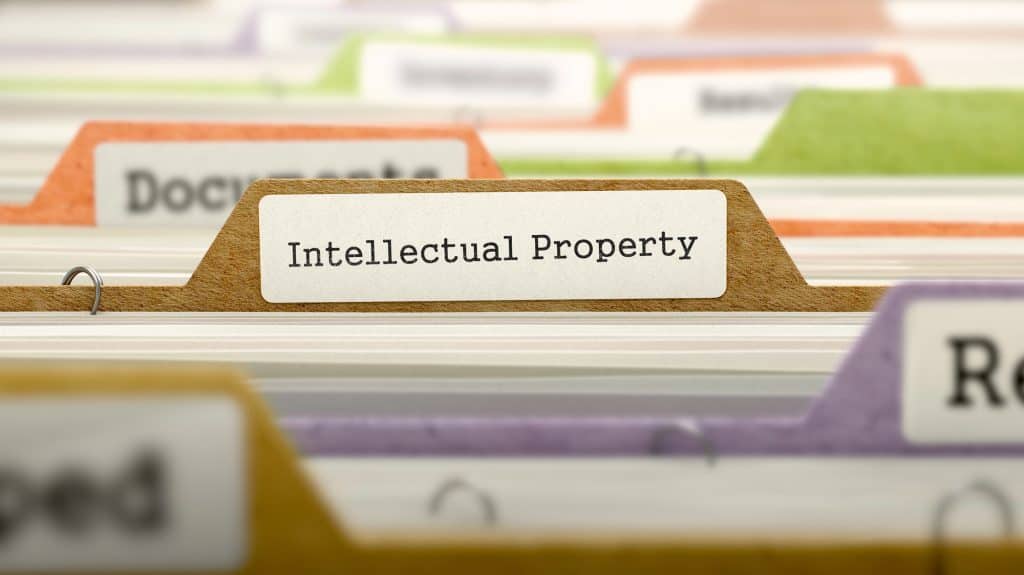 A close-up of a file tab labeled "Intellectual Property" among a set of organized folders in various colors.