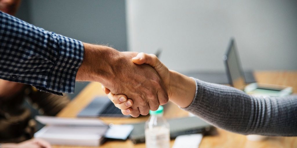 Two people shaking hands together.